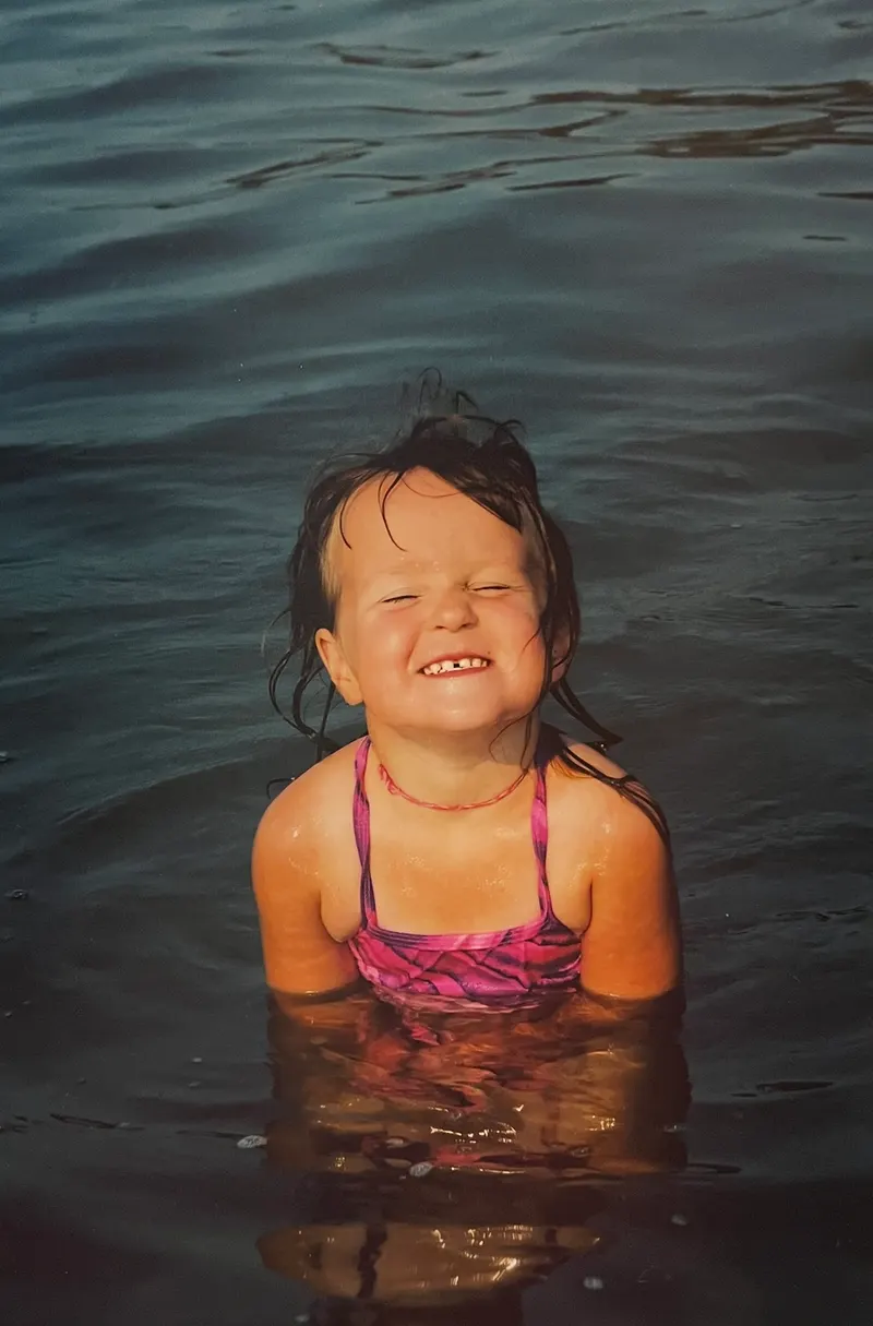 Gill as a child smiling in the water